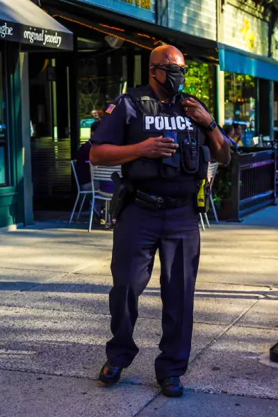Police Brutality 1 a man wearing a mask and a police uniform