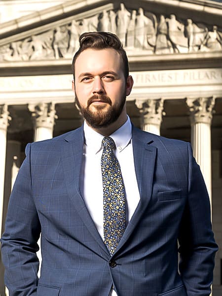 Glen Ahlers, construction accident attorney, standing in front of of New York City court.