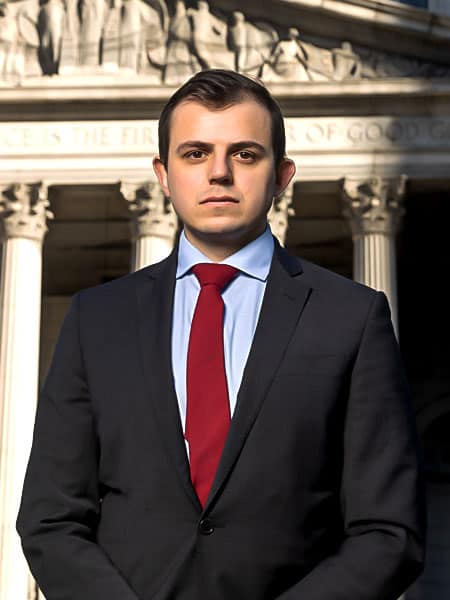 Zahar Buniak, personal injury attorney, standing in front of of New York City court.